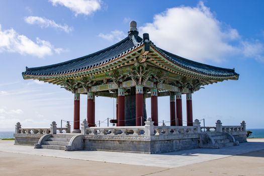 The Korean Friendship Bell pavilion under a clear blue sky in San Pedro, California.