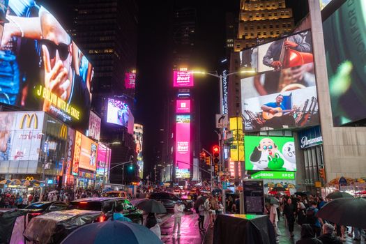 Experience the vibrant nightlife of Times Square, New York City, with brilliant lights and bustling crowds.