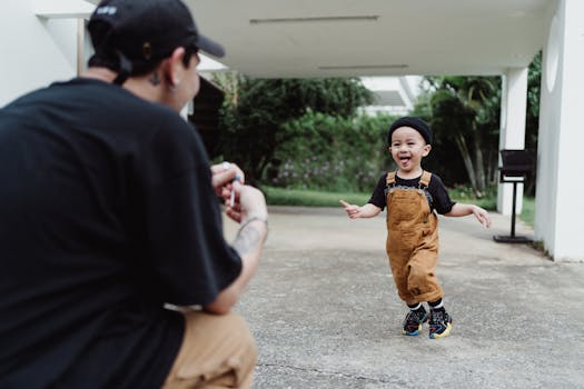 Joyful moment of a father and son playing outdoors, capturing a happy family time.
